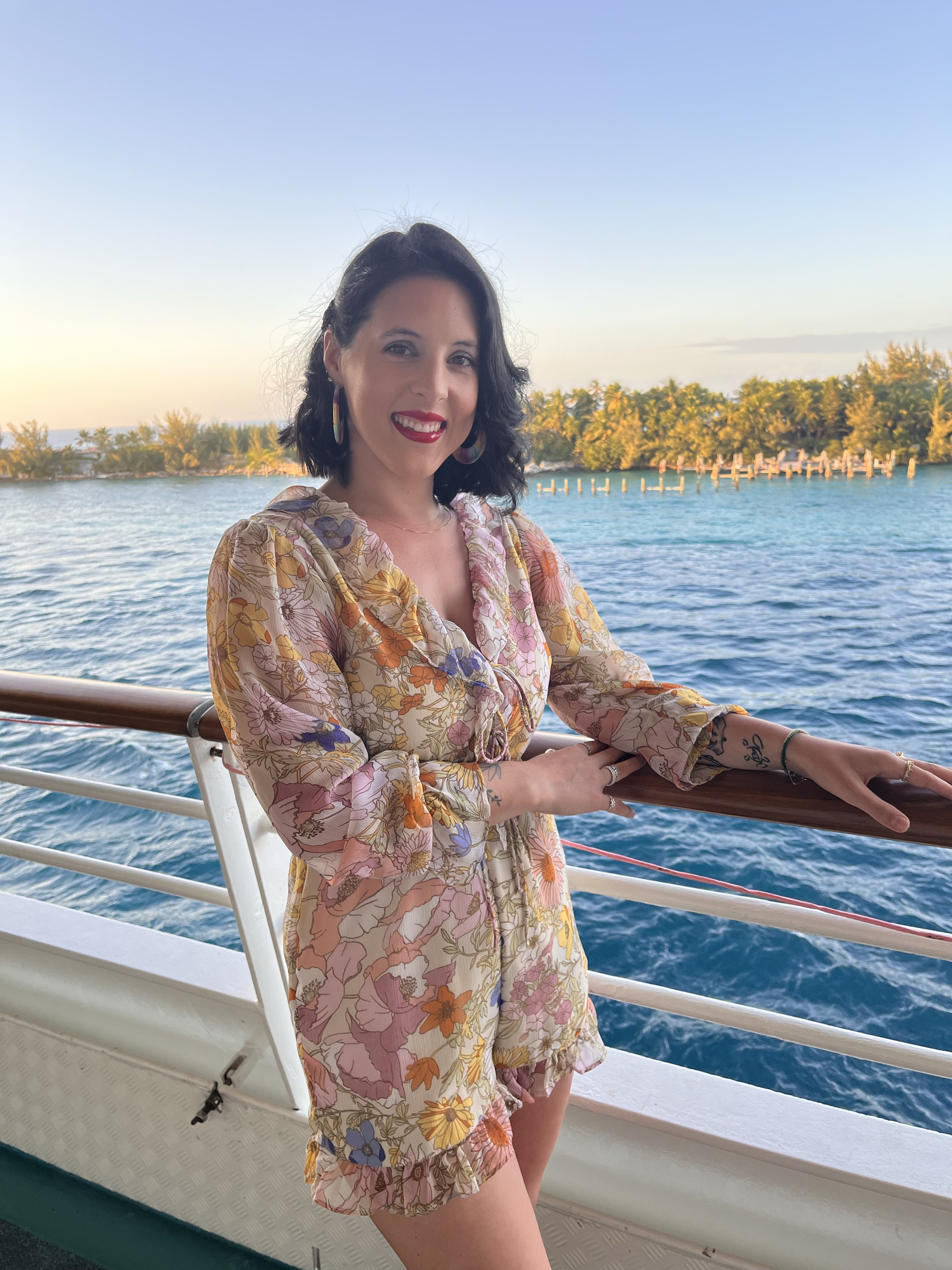 Callan standing on a boat at sunset